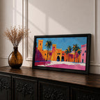 Panoramic painting of a Moroccan kasbah with tall palm trees and arched fortress gates rendered in bold palette knife brushstrokes. Bright orange, pink, and terracotta buildings contrast against a vivid blue sky, capturing the architecture of a Marrakech medina with textured walls and sunlit desert tones.