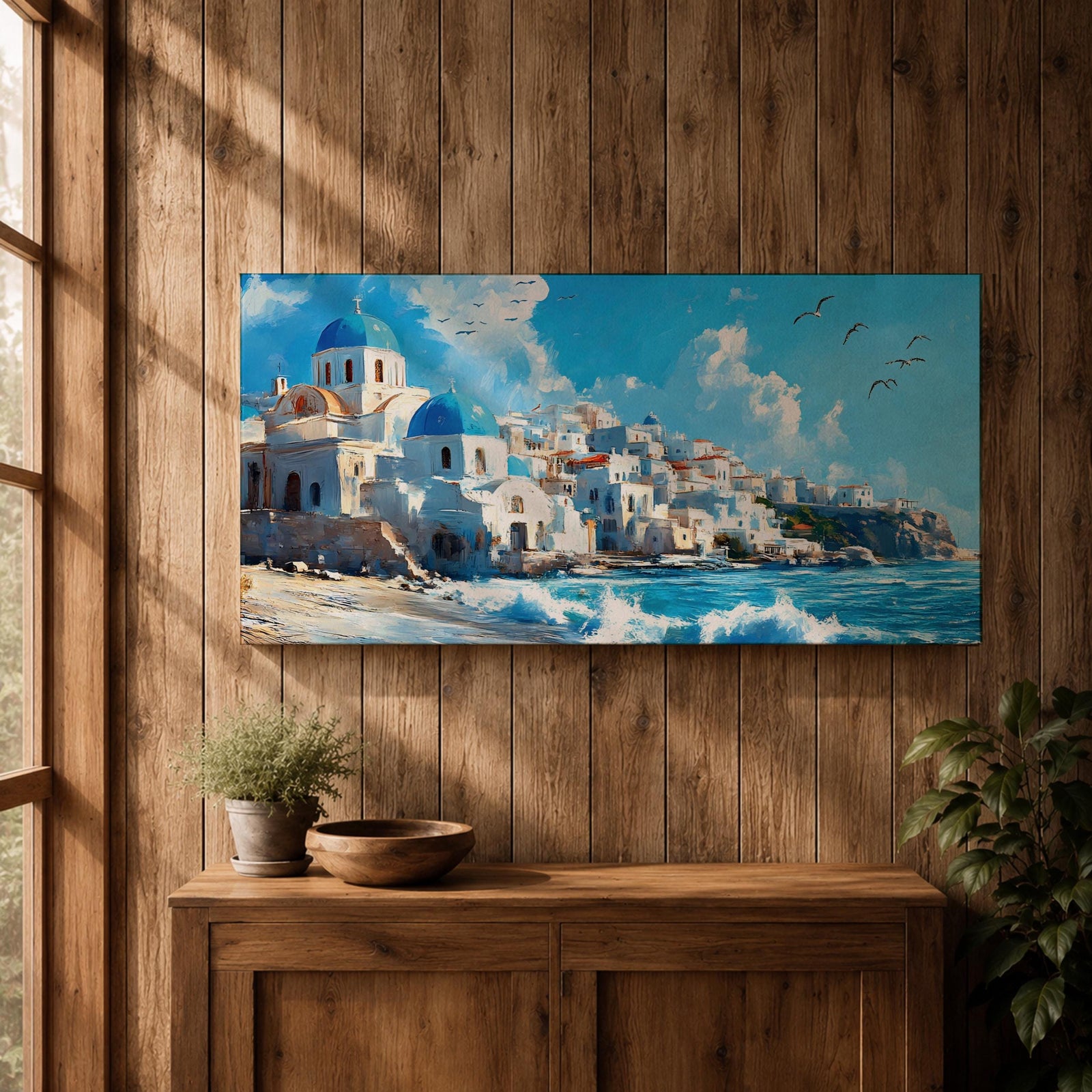 Panoramic painting of Santorini’s coastal village with whitewashed houses and blue domed churches overlooking the Aegean Sea. Waves crash along the shoreline beneath sunlit buildings stacked across the hillside, while seabirds glide through a bright blue sky with soft clouds above the Mediterranean landscape.