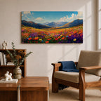 Panoramic painting of a vibrant mountain meadow filled with colorful wildflowers stretching toward distant alpine peaks. Red, yellow, purple, and blue blossoms cover the valley floor beneath a bright sky with soft clouds, while layered mountains rise along the horizon in a luminous natural landscape.