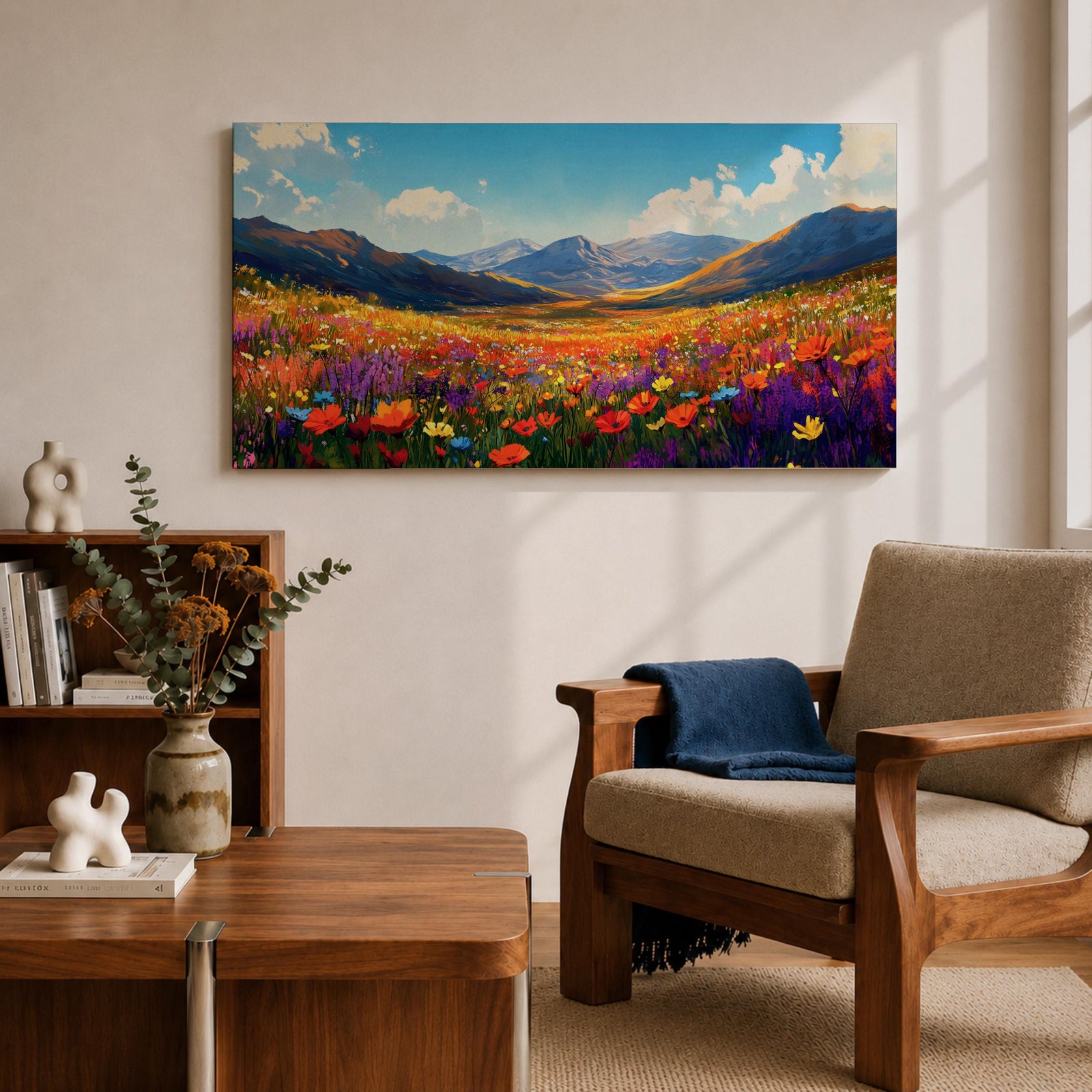 Panoramic painting of a vibrant mountain meadow filled with colorful wildflowers stretching toward distant alpine peaks. Red, yellow, purple, and blue blossoms cover the valley floor beneath a bright sky with soft clouds, while layered mountains rise along the horizon in a luminous natural landscape.