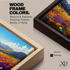 Panoramic painting of a vibrant mountain meadow filled with colorful wildflowers stretching toward distant alpine peaks. Red, yellow, purple, and blue blossoms cover the valley floor beneath a bright sky with soft clouds, while layered mountains rise along the horizon in a luminous natural landscape.
