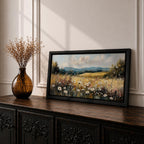 Panoramic painting of a peaceful wildflower meadow filled with blooming daisies and tall grasses across rolling countryside fields. Soft clouds stretch above distant hills while warm golden tones and textured brushstrokes create a calm rural landscape scene.