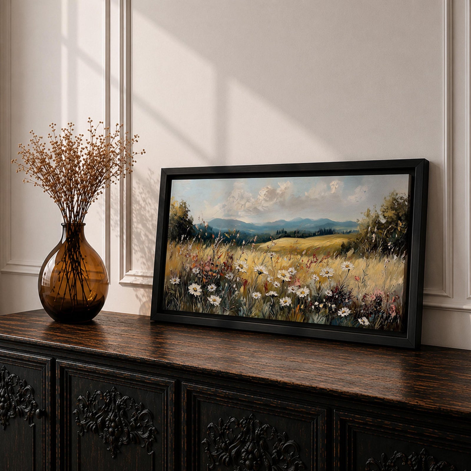 Panoramic painting of a peaceful wildflower meadow filled with blooming daisies and tall grasses across rolling countryside fields. Soft clouds stretch above distant hills while warm golden tones and textured brushstrokes create a calm rural landscape scene.