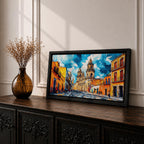 Panoramic painting of Oaxaca cathedral rising above a colorful colonial street lined with bright orange and yellow buildings. The historic Mexican architecture features twin cathedral towers beneath a dramatic blue sky with expressive painterly brushstrokes.