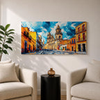 Panoramic painting of Oaxaca cathedral rising above a colorful colonial street lined with bright orange and yellow buildings. The historic Mexican architecture features twin cathedral towers beneath a dramatic blue sky with expressive painterly brushstrokes.