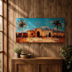Panoramic painting of a Moroccan kasbah surrounded by palm trees in a desert oasis with the Atlas Mountains rising in the distance. The warm earthen architecture contrasts with a bright blue sky and textured brushstrokes capturing North African landscape scenery.