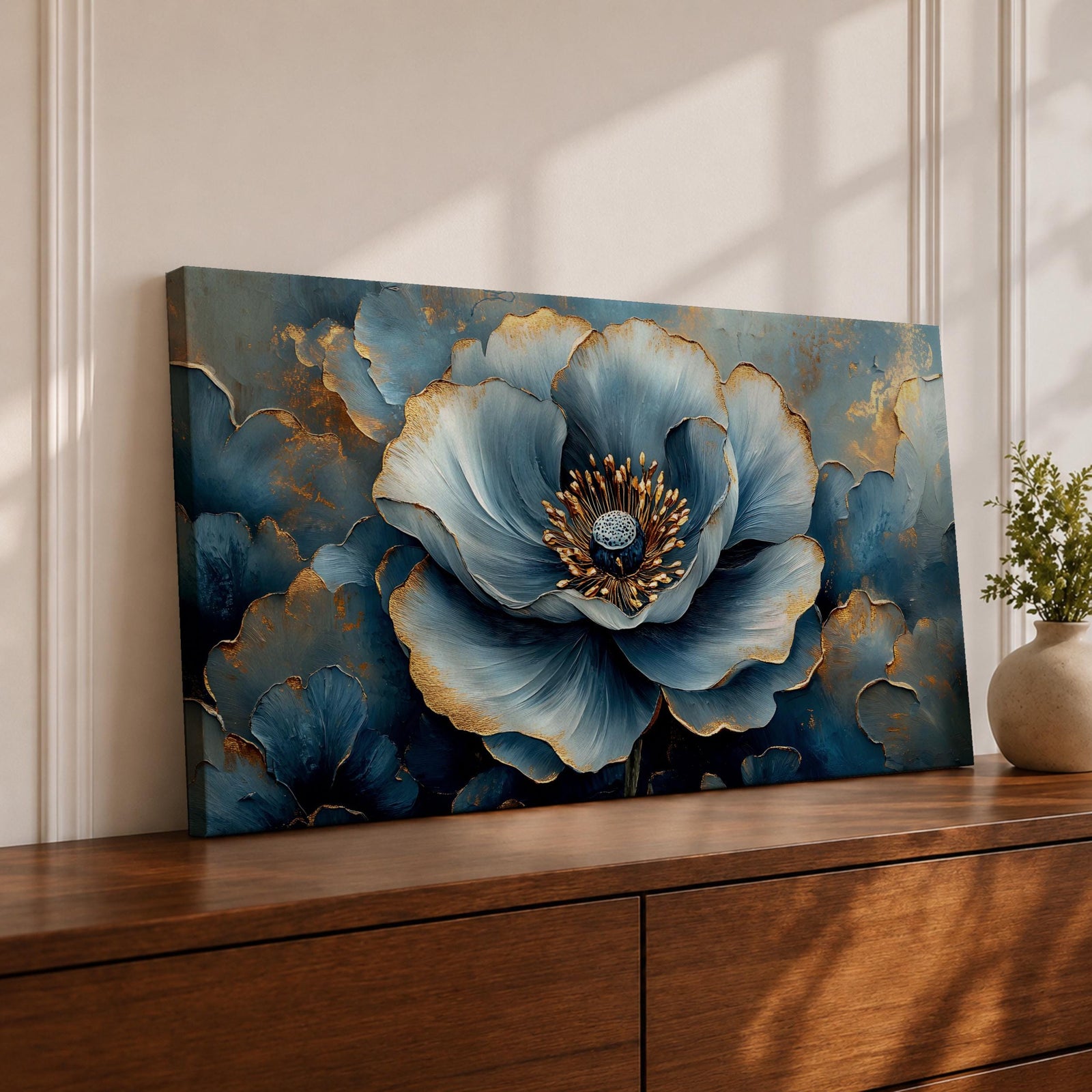 Panoramic floral artwork featuring a large blue poppy bloom with layered petals highlighted by soft gold accents and textured brushstrokes. The central flower is surrounded by additional blue blossoms and dark botanical forms creating depth, with rich blue tones and metallic details emphasizing the petals and center of the flower.