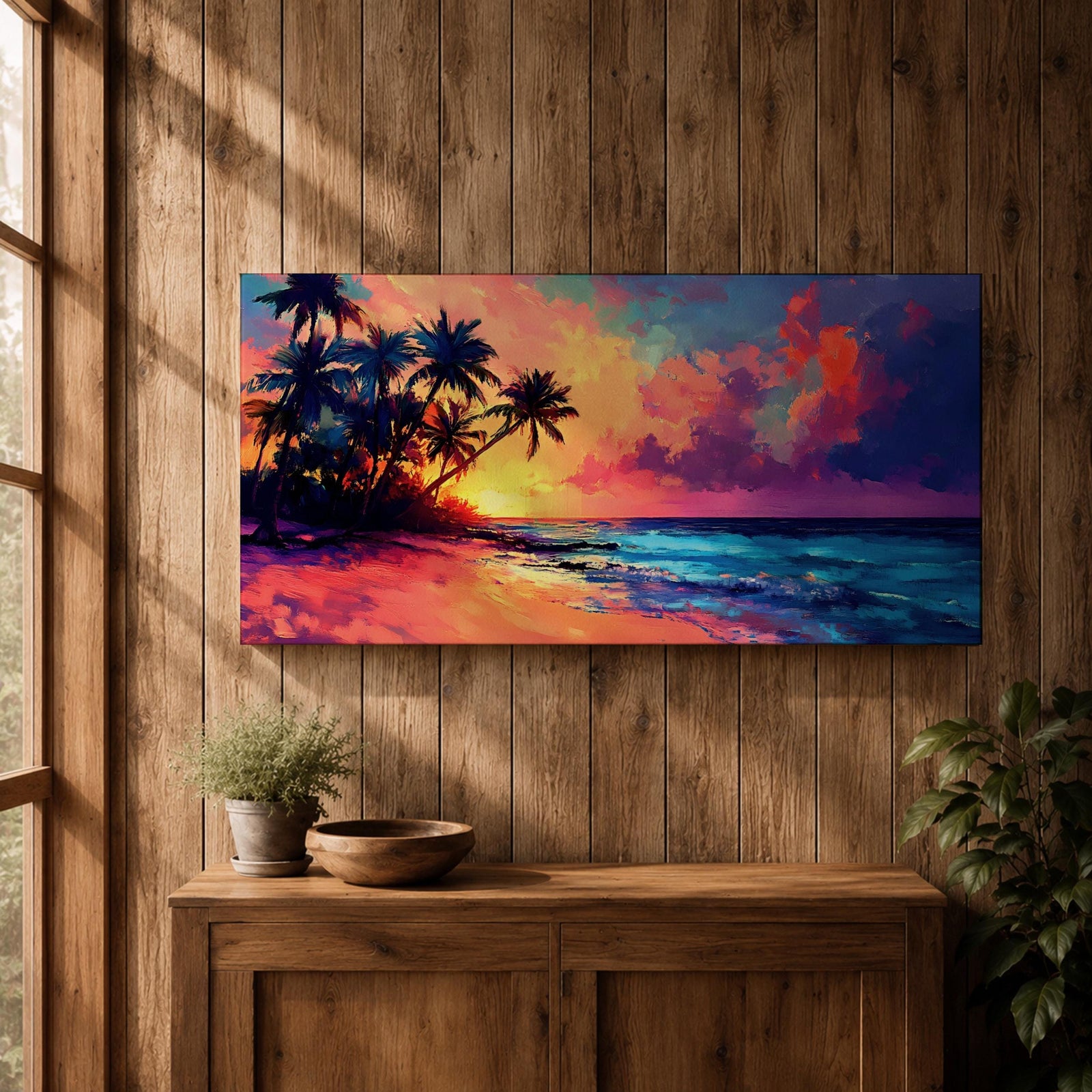Panoramic tropical beach painting featuring tall palm trees leaning over a sandy shoreline as waves meet the coast beneath a vivid sunset. The sky glows with bold colors of orange, pink, purple, and blue reflecting across the ocean water, creating a dramatic island sunset scene with expressive brushstrokes.