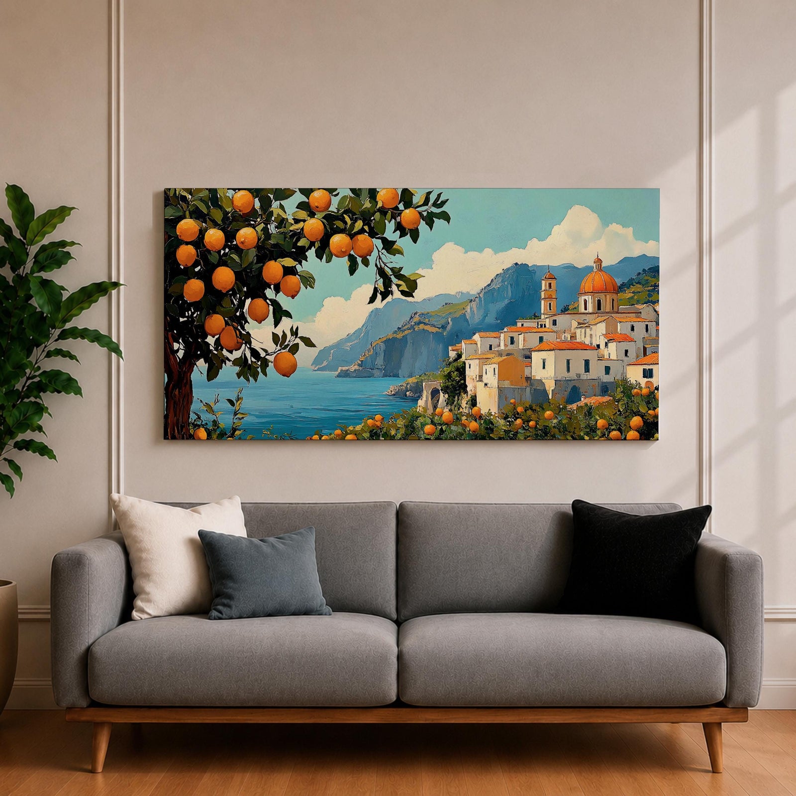 Panoramic coastal artwork showing a Mediterranean village overlooking the sea with white buildings and a domed church set against blue mountains. In the foreground a large lemon tree heavy with bright citrus fruit frames the scene while additional lemons and greenery fill the lower landscape, creating a vibrant Amalfi Coast inspired composition.