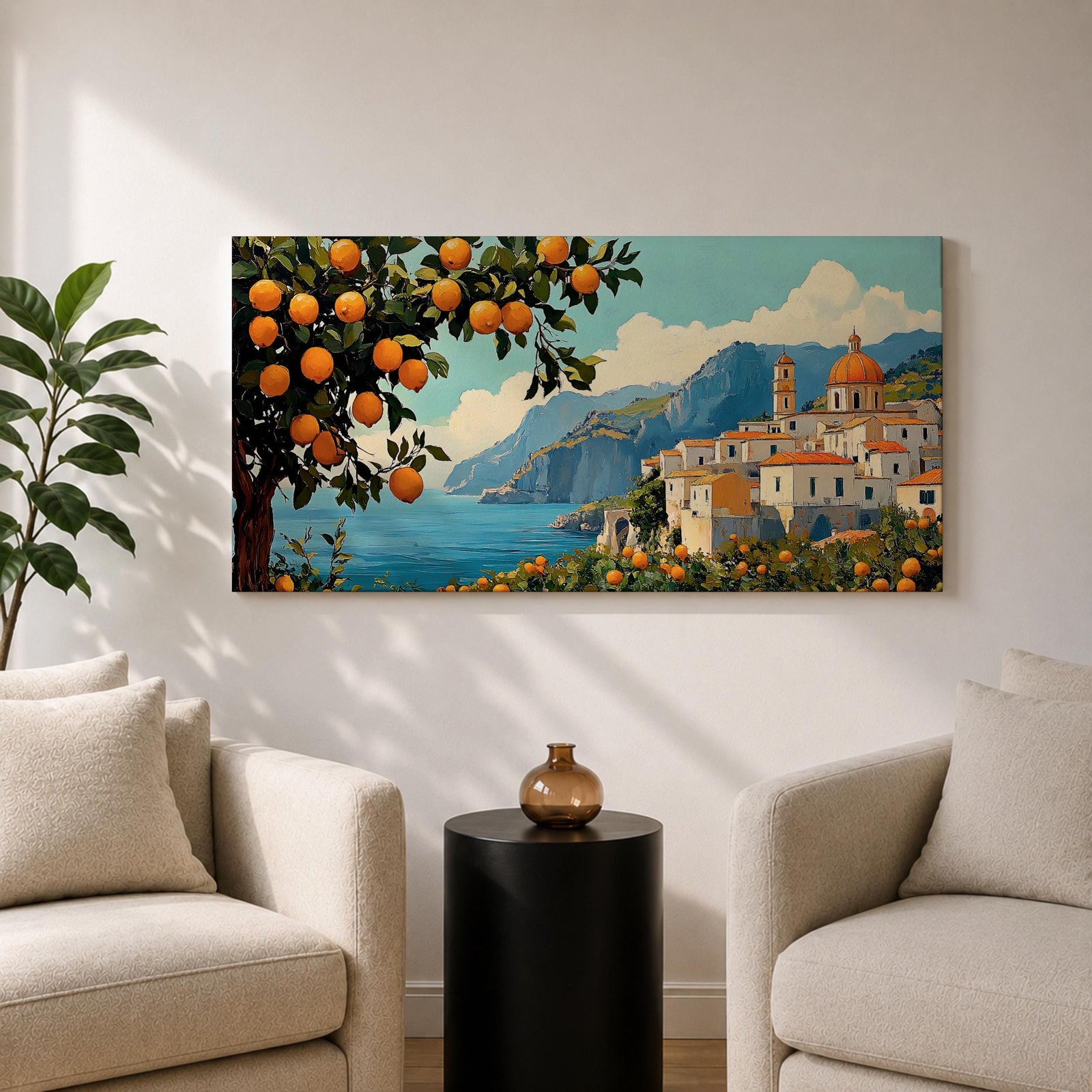 Panoramic coastal artwork showing a Mediterranean village overlooking the sea with white buildings and a domed church set against blue mountains. In the foreground a large lemon tree heavy with bright citrus fruit frames the scene while additional lemons and greenery fill the lower landscape, creating a vibrant Amalfi Coast inspired composition.