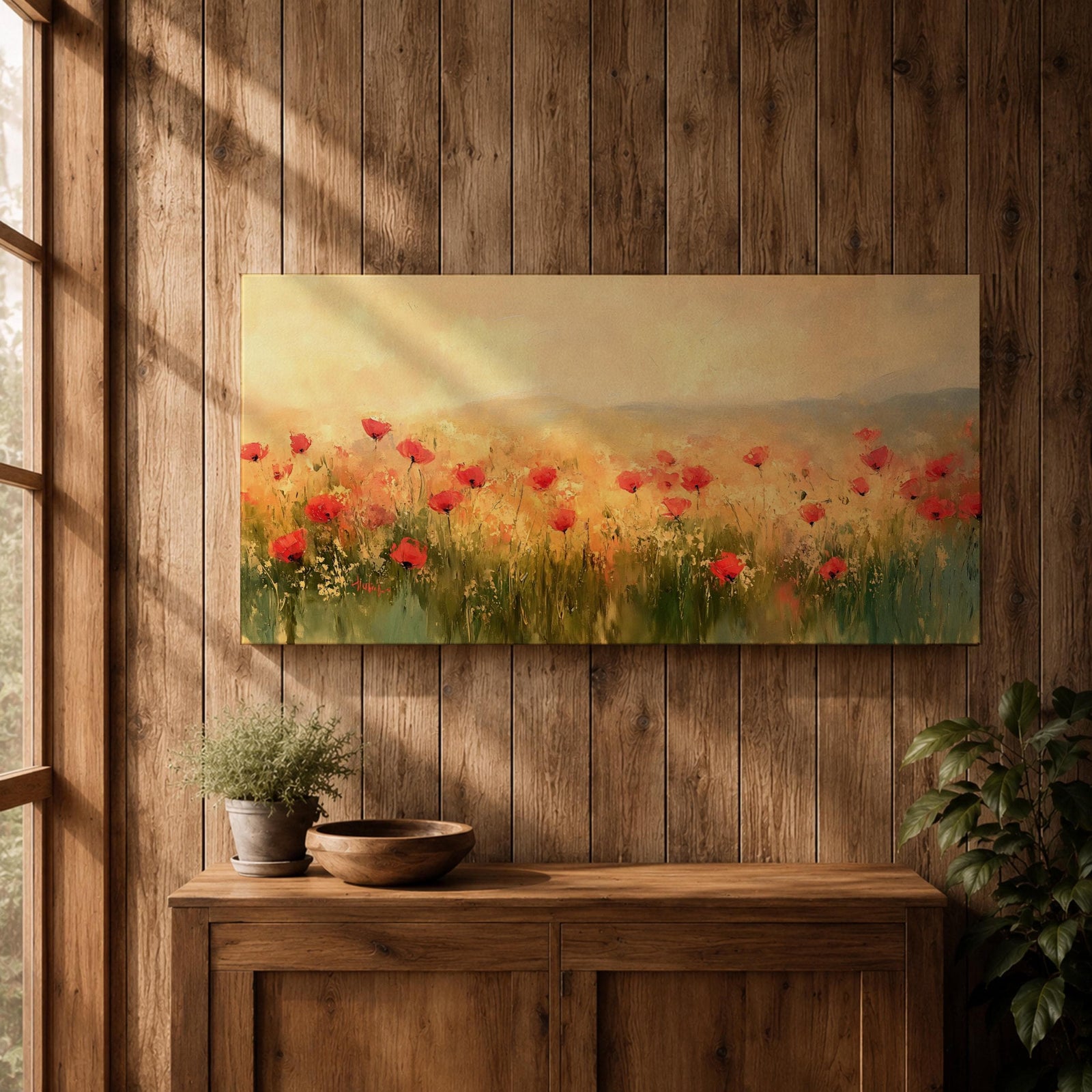 Panoramic painting of a wild poppy field filled with red blossoms scattered across tall grasses and soft meadow plants. The scene shows glowing golden light across the landscape with distant hills fading into a warm sky, while loose brushstrokes capture the movement of wildflowers spread across the field.