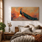 Panoramic artwork depicting a peacock standing on a rocky hill with its long iridescent tail feathers flowing behind it. The bird faces a glowing sunset with warm orange clouds and soft light illuminating the detailed blue and green plumage while flowering trees frame the scene.