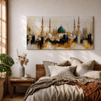 Panoramic painting depicting Masjid Nabawi in Madinah with the iconic green dome rising above the mosque complex surrounded by tall minarets and domes. The skyline is rendered with expressive brushstrokes and warm gold and neutral tones highlighting the sacred Islamic architecture.