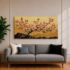 A panoramic painting of a flowering cherry blossom branch extending across the composition with clusters of soft pink sakura flowers and dark textured bark, set against a rich gold background with distant mountain silhouettes, rendered in a Japanese inspired style with detailed petals and balanced horizontal composition.