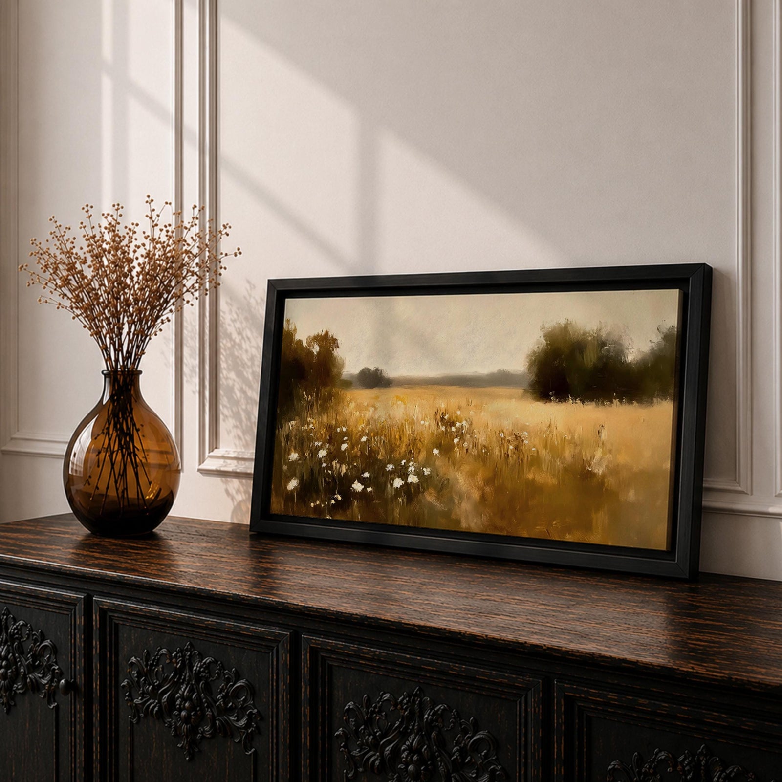 A panoramic painting of a golden meadow filled with tall grasses and scattered white wildflowers stretching across an open countryside field toward a distant horizon, bordered by darker tree clusters and rendered with soft impressionist brushstrokes in warm earthy tones that create depth and a quiet rural atmosphere.