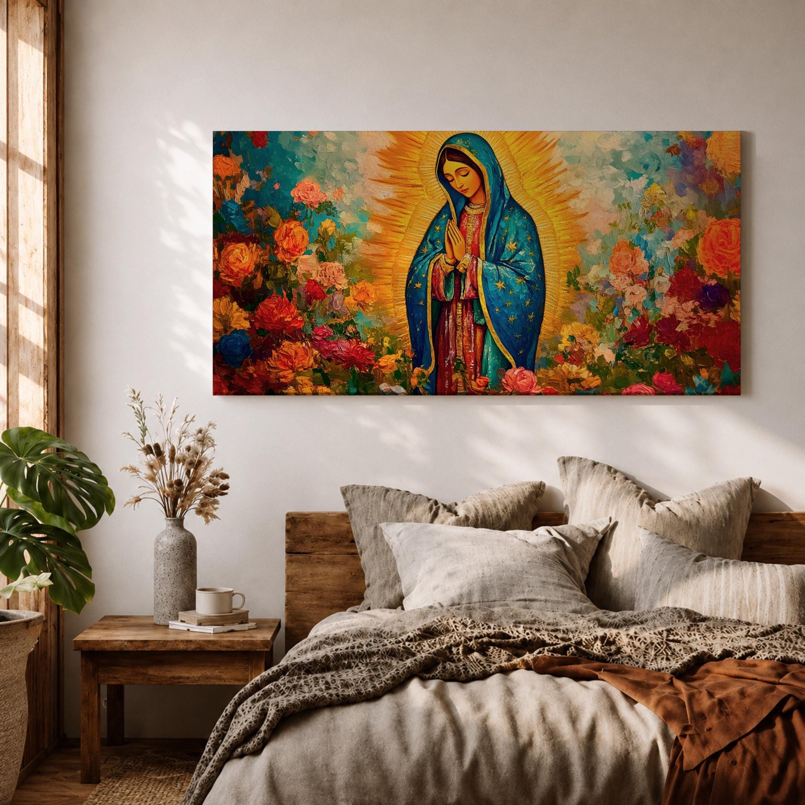 A panoramic painting of the Virgin Mary depicted as Our Lady of Guadalupe standing in prayer with hands together, wearing a blue star covered mantle and red dress, surrounded by radiant golden light and vibrant blooming flowers in rich reds, pinks, and oranges painted with expressive textured brushstrokes.