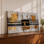 Panoramic painting of the Kaaba in Mecca centered within Masjid al Haram featuring the black cube sanctuary draped in the kiswah with gold calligraphy bands. Tall mosque minarets and long arched colonnades frame the courtyard while bold gold abstract paint textures and layered architectural lines extend across the wide horizontal composition.