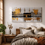 Panoramic painting of the Kaaba in Mecca centered within Masjid al Haram featuring the black cube sanctuary draped in the kiswah with gold calligraphy bands. Tall mosque minarets and long arched colonnades frame the courtyard while bold gold abstract paint textures and layered architectural lines extend across the wide horizontal composition.