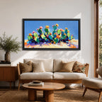 Panoramic painting of desert prickly pear cactus plants with bright pink and yellow blooming flowers growing across a colorful arid landscape. Thick palette knife brushstrokes create textured cactus pads vibrant blossoms and layered desert hills beneath a glowing sky forming a wide southwestern desert scene.