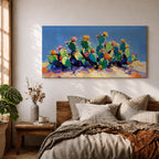 Panoramic painting of desert prickly pear cactus plants with bright pink and yellow blooming flowers growing across a colorful arid landscape. Thick palette knife brushstrokes create textured cactus pads vibrant blossoms and layered desert hills beneath a glowing sky forming a wide southwestern desert scene.