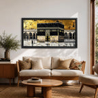 Panoramic gold and black painting of the Kaaba at Masjid al Haram in Mecca, showing the cubed sanctuary draped in the black kiswah with gold calligraphy bands. Surrounding mosque arches and marble courtyard stretch across the horizontal composition while small pilgrim figures circle the Kaaba creating scale and depth.