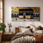Panoramic gold and black painting of the Kaaba at Masjid al Haram in Mecca, showing the cubed sanctuary draped in the black kiswah with gold calligraphy bands. Surrounding mosque arches and marble courtyard stretch across the horizontal composition while small pilgrim figures circle the Kaaba creating scale and depth.