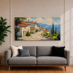 Panoramic painting of a Mediterranean hillside village with warm stone houses and terracotta roofs overlooking the rolling Tuscany hills. Thick palette knife brushstrokes create textured buildings cypress trees and layered green landscapes beneath a glowing sky forming a wide Italian countryside scene.