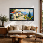 Panoramic painting of a Mediterranean hillside village with warm stone houses and terracotta roofs overlooking the rolling Tuscany hills. Thick palette knife brushstrokes create textured buildings cypress trees and layered green landscapes beneath a glowing sky forming a wide Italian countryside scene.