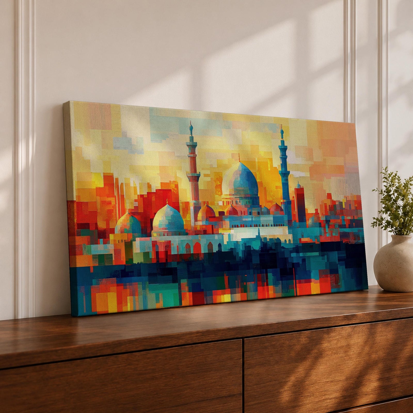 Panoramic abstract painting of Al Masjid an Nabawi in Medina featuring the mosque domes and tall minarets with the iconic green dome at the center. The architecture is rendered with geometric block brushstrokes in vibrant blues, reds, yellows and oranges creating a modern cityscape style composition.