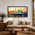 Panoramic abstract painting of Al Masjid an Nabawi in Medina featuring the mosque domes and tall minarets with the iconic green dome at the center. The architecture is rendered with geometric block brushstrokes in vibrant blues, reds, yellows and oranges creating a modern cityscape style composition.