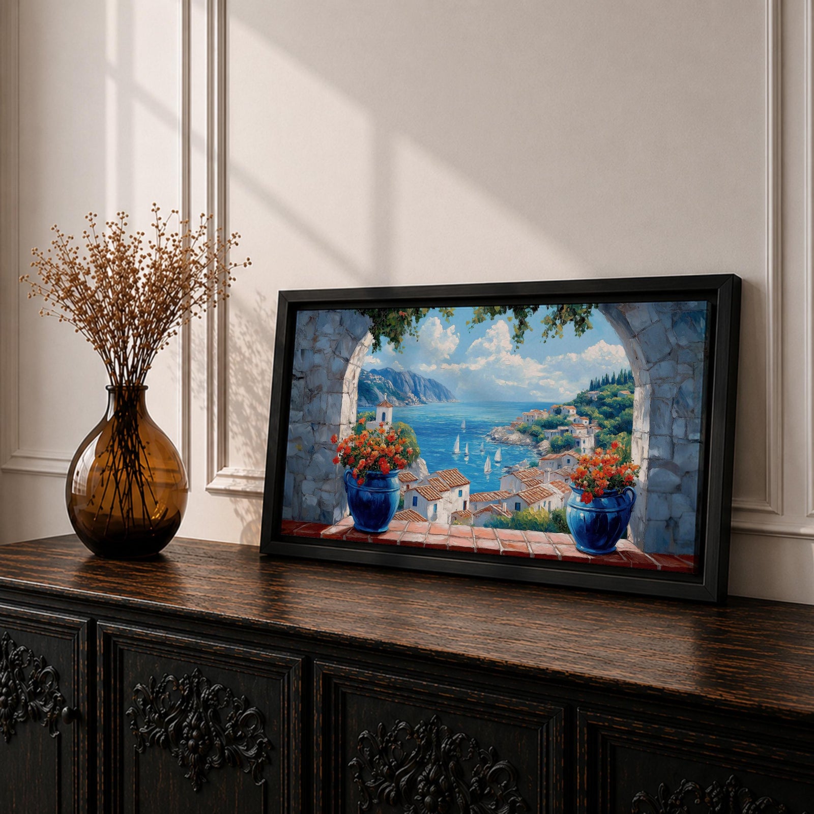 A panoramic painting of a Mediterranean seaside village viewed through a stone arch window, featuring blue ocean waters, sailboats, terracotta rooftops, and vibrant floral pots.