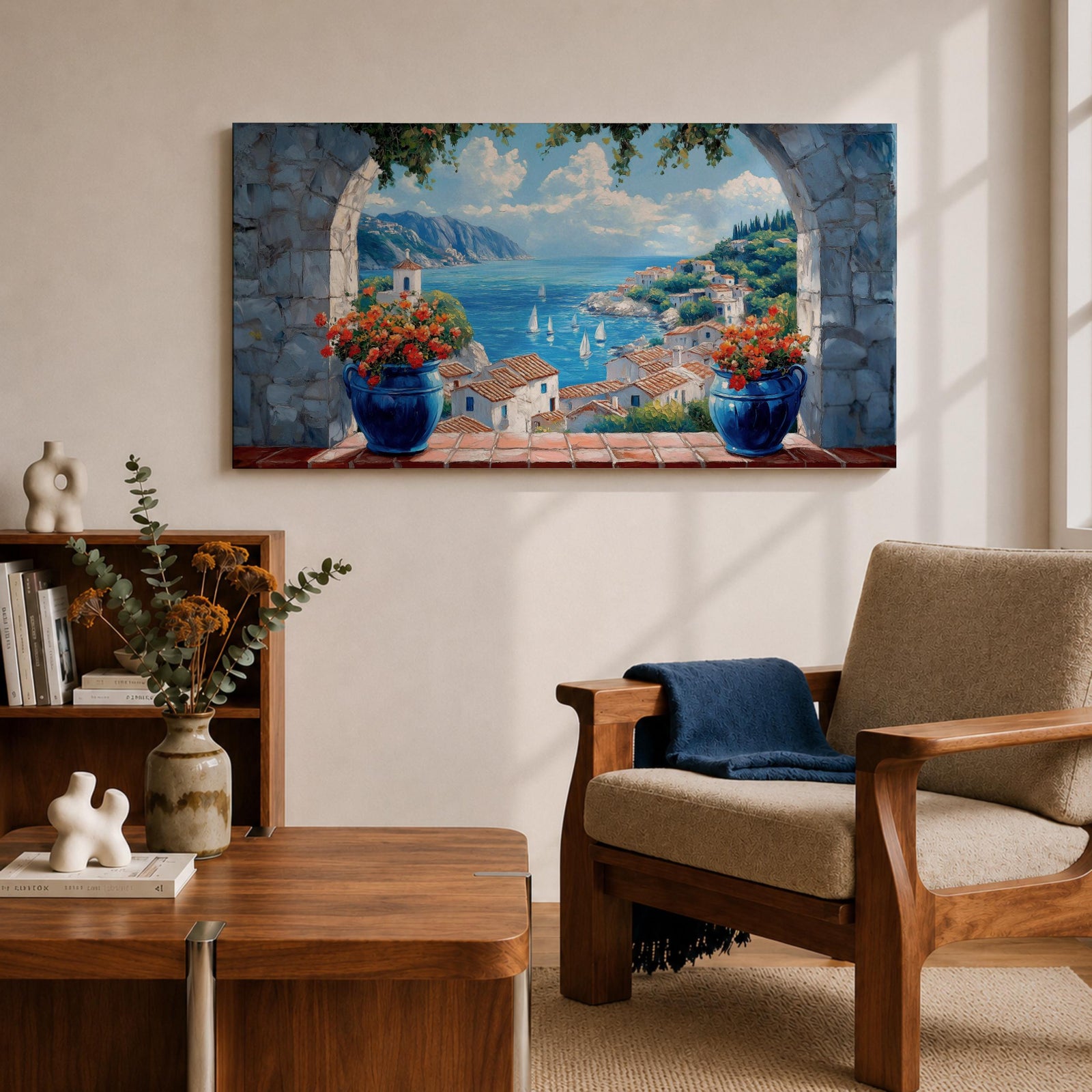 A panoramic painting of a Mediterranean seaside village viewed through a stone arch window, featuring blue ocean waters, sailboats, terracotta rooftops, and vibrant floral pots.