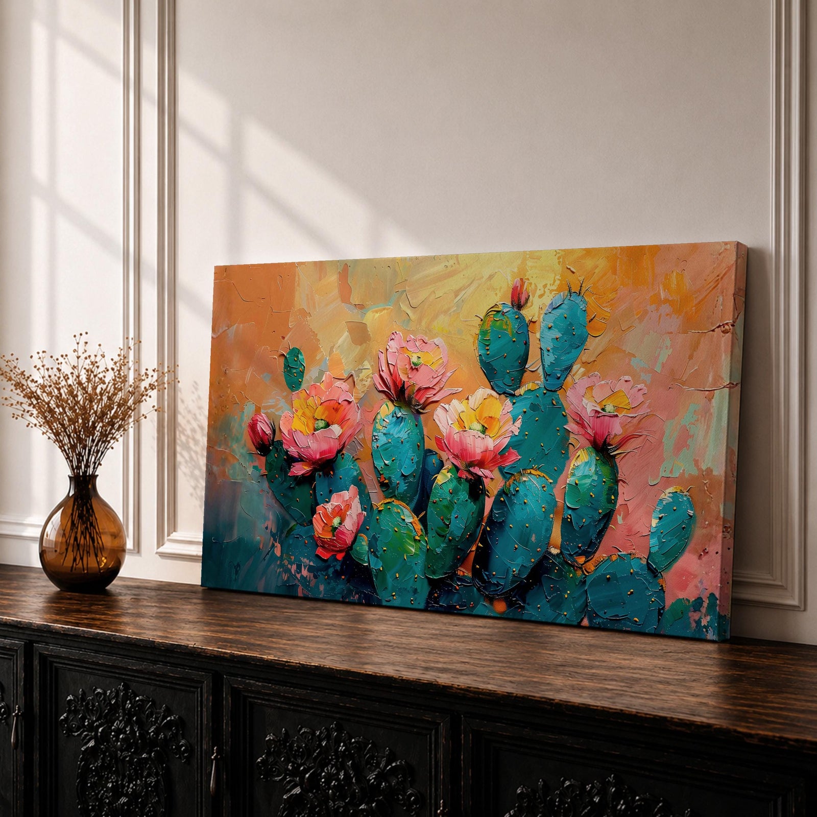 A panoramic textured painting of prickly pear cactus pads in rich teal tones adorned with blooming pink and coral flowers, set against a warm abstract desert background of golden orange and soft pastels, rendered with thick brushstrokes that create depth, contrast, and a vibrant southwestern composition.