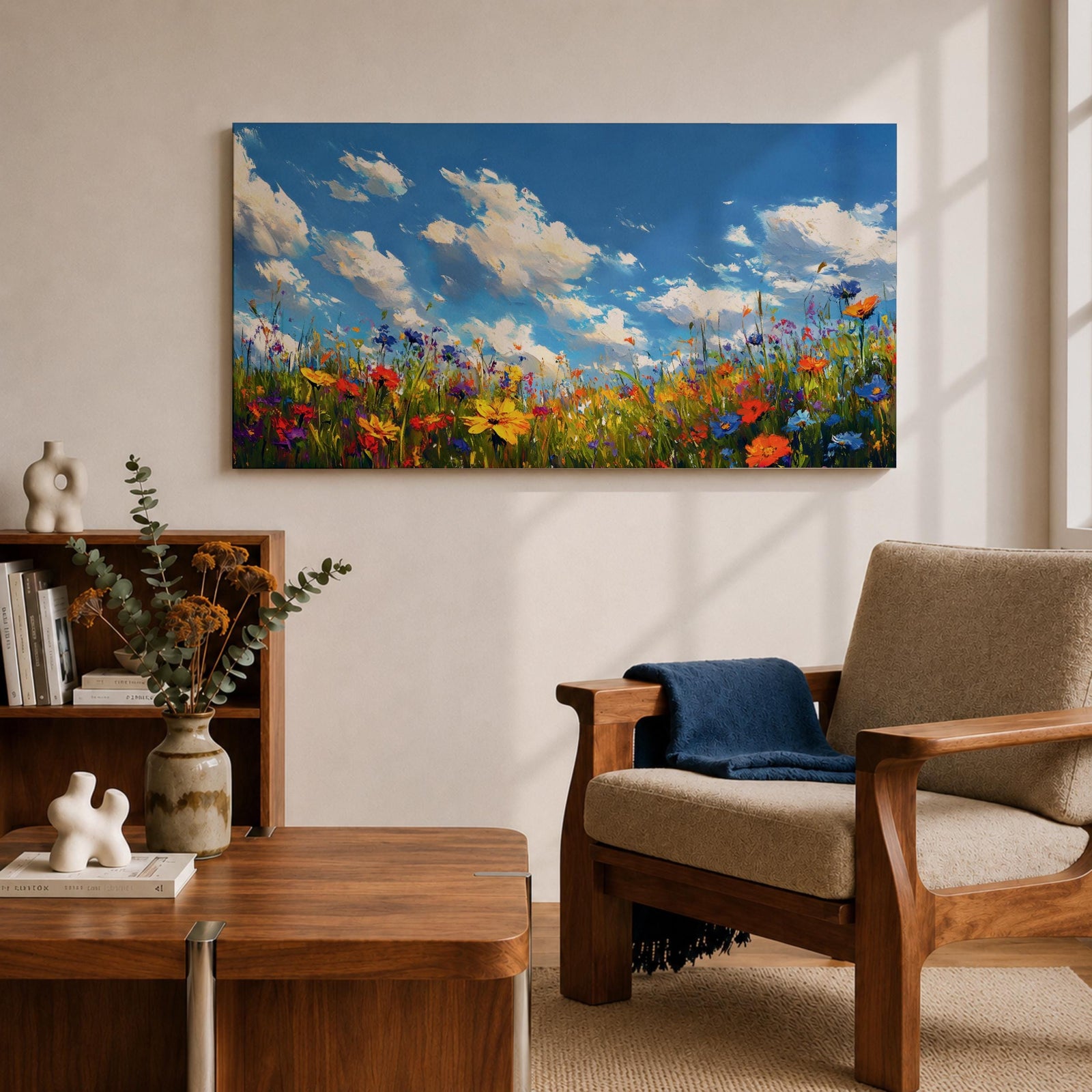 A panoramic painting of a colorful wildflower meadow under a bright blue sky with soft clouds, creating a vibrant and uplifting landscape scene.
