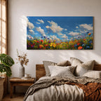 A panoramic painting of a colorful wildflower meadow under a bright blue sky with soft clouds, creating a vibrant and uplifting landscape scene.