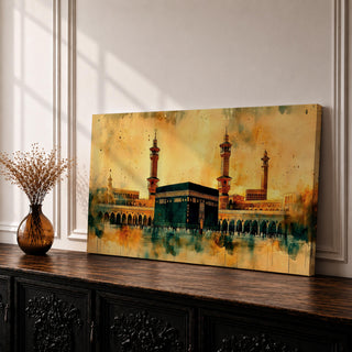A panoramic watercolor-style painting of the Kaaba in Mecca with soft blended tones of gold, green, and beige, featuring subtle architectural details and a fluid artistic background.