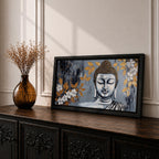 Panoramic painting of a serene Buddha portrait with closed eyes rendered in textured gray and gold tones. The composition features golden leaves and white blossoms surrounding the calm face, with layered brushstrokes and metallic accents creating contrast against a dark abstract background.