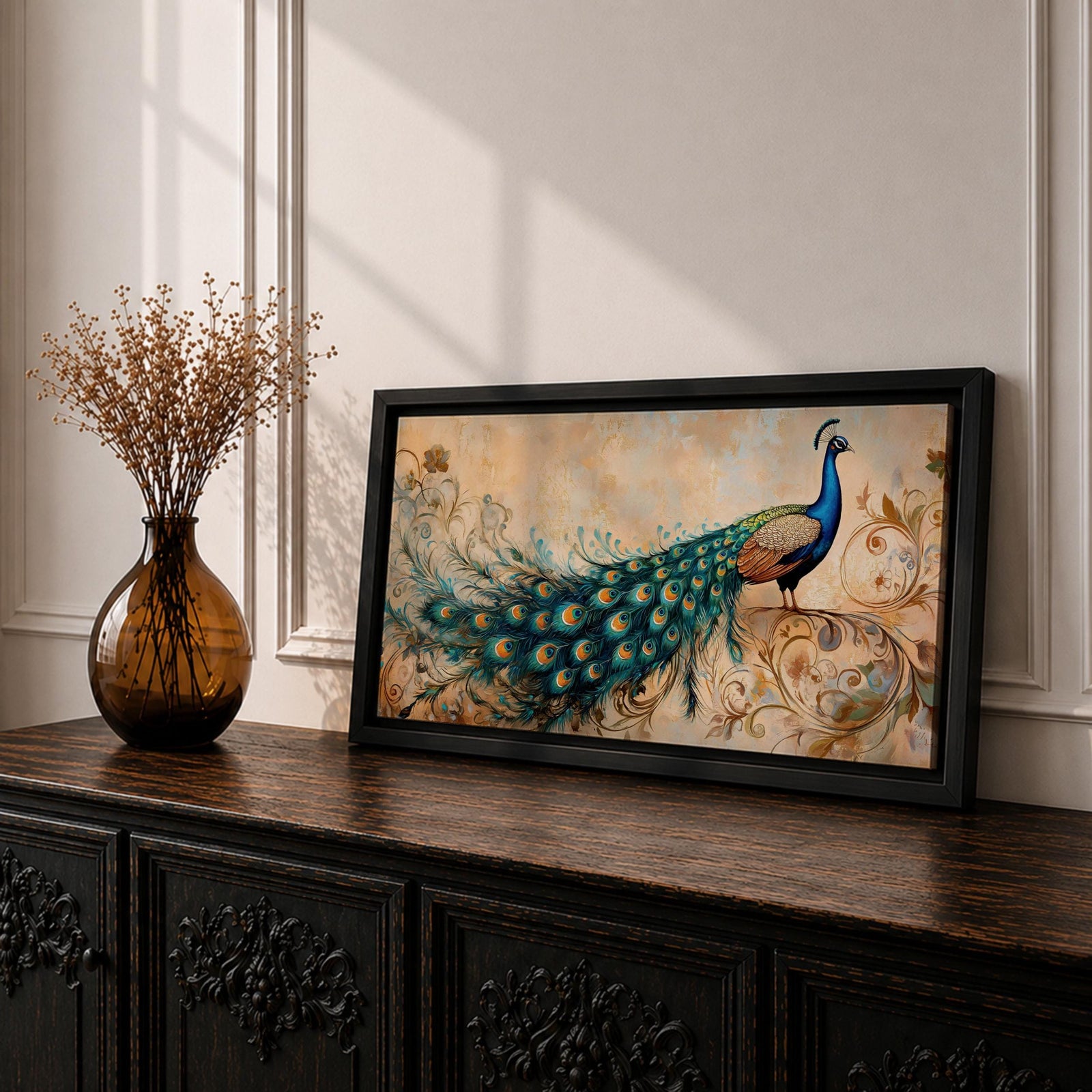 Panoramic painting of a peacock perched with an elongated flowing tail filled with vibrant blue, teal, and gold eye patterned feathers. The composition includes ornate botanical scrolls and floral motifs surrounding the bird, rendered with textured brushwork against a warm neutral background.