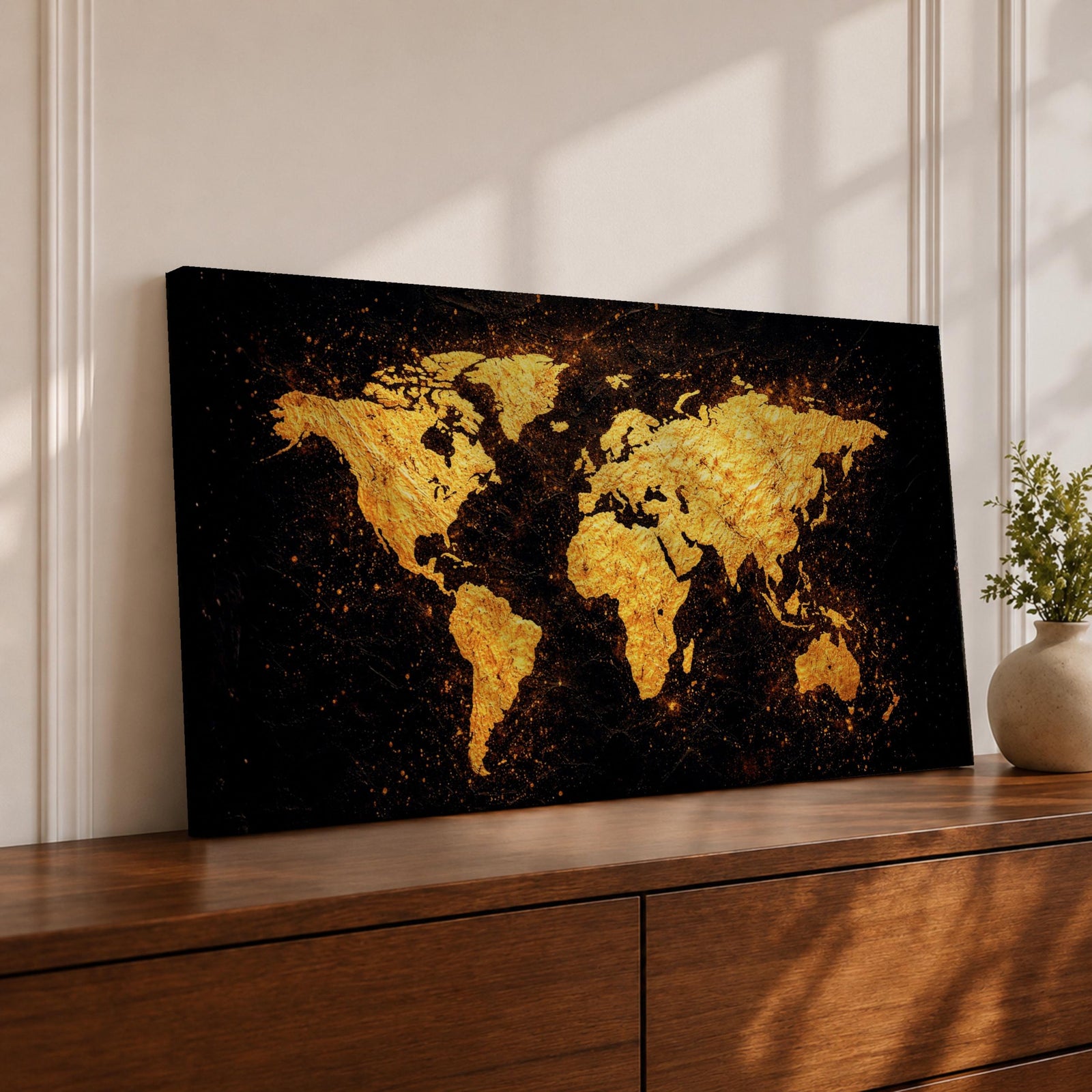 Panoramic artwork of a world map rendered in textured metallic gold against a deep black background. The continents appear with rough painterly edges and splattered gold accents, creating a bold global composition with strong contrast and modern map styling.
