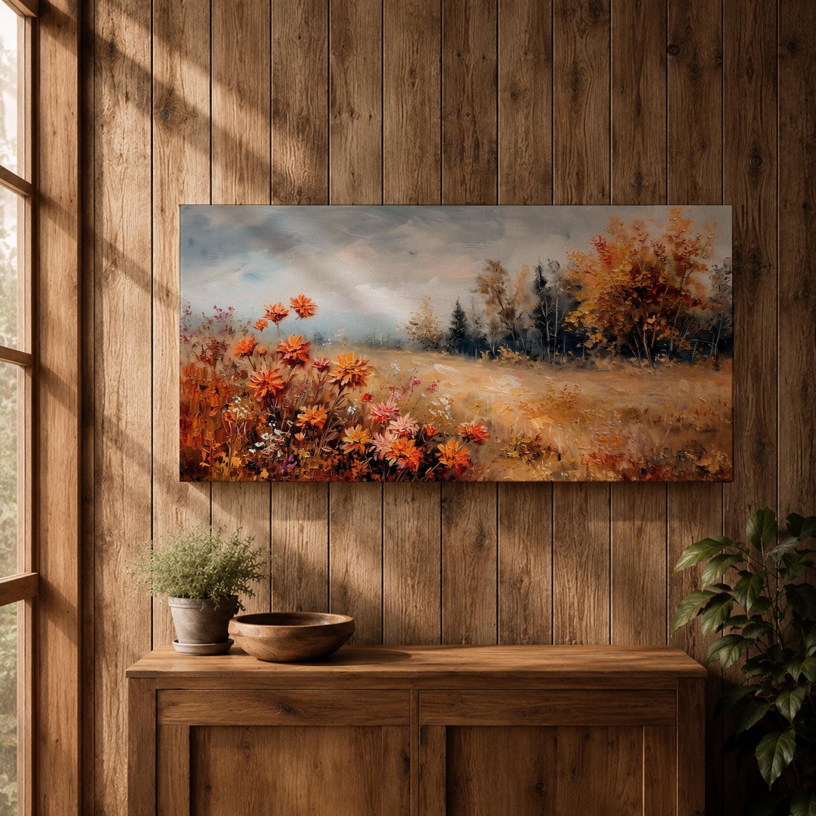 Panoramic landscape painting of an autumn meadow filled with orange wildflowers and golden grasses stretching toward a distant treeline. Soft textured brushstrokes depict fall foliage and a muted cloudy sky, creating a warm countryside scene with natural seasonal colors.