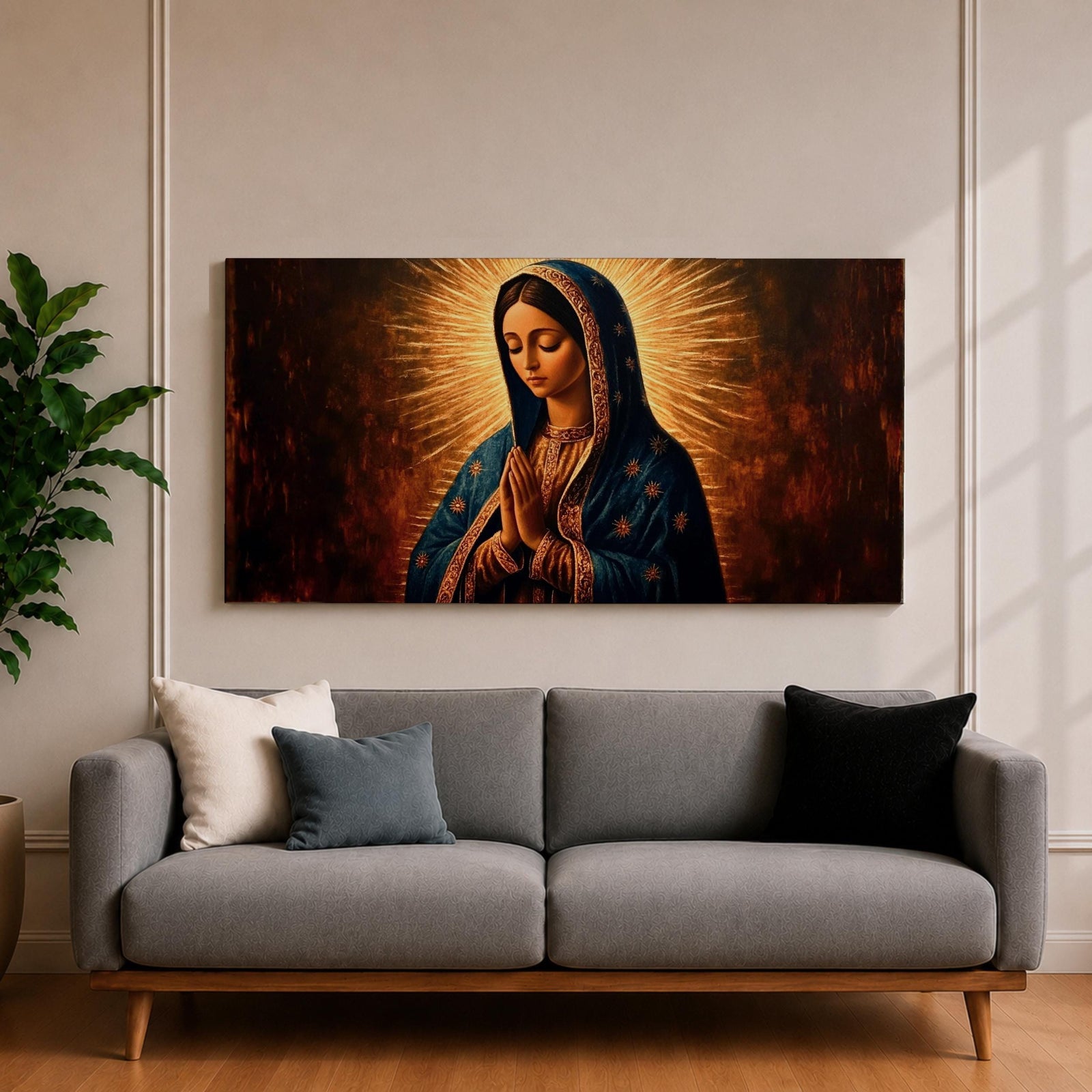 Panoramic religious painting of the Virgin Mary praying with hands together and head bowed, surrounded by a radiant golden halo against a warm dark background.