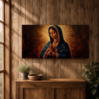 Panoramic religious painting of the Virgin Mary praying with hands together and head bowed, surrounded by a radiant golden halo against a warm dark background.