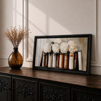 Panoramic still life painting of white hydrangea flowers arranged inside stacked vintage books with neutral beige and cream tones in a soft textured background.