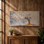 Panoramic artwork of a white blossoming tree with a flowing golden trunk and roots spreading across a textured gray background symbolizing the tree of life.