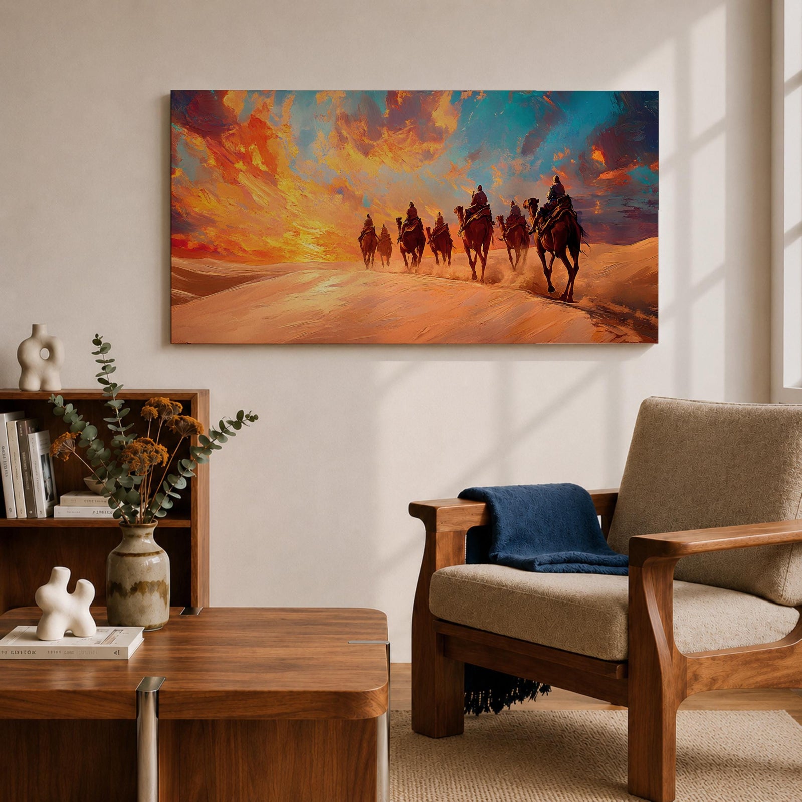 Panoramic painting of a camel caravan traveling across golden desert dunes at sunset with riders silhouetted beneath a vibrant dramatic sky.