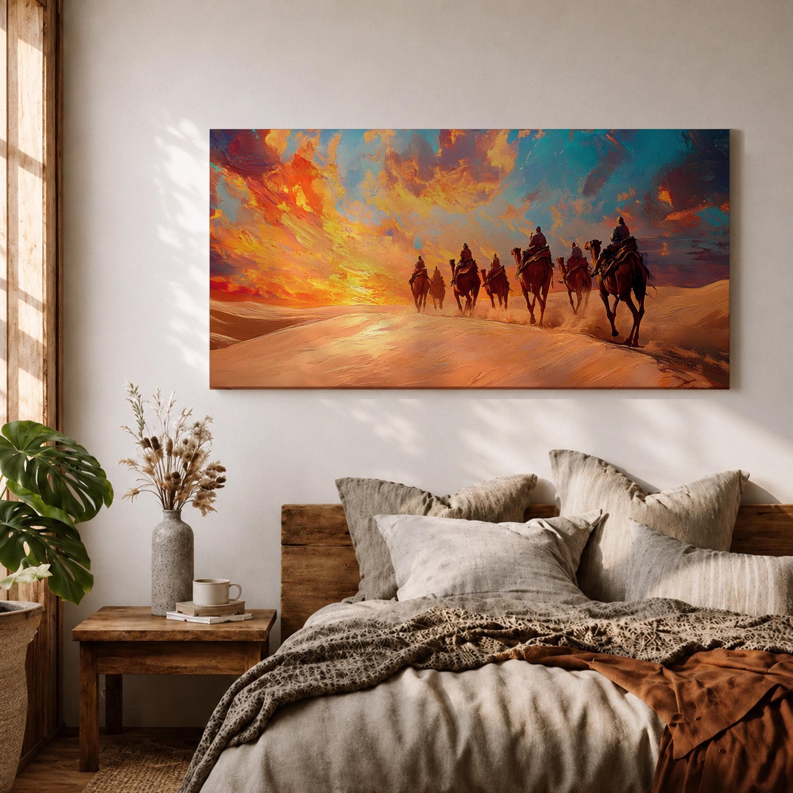 Panoramic painting of a camel caravan traveling across golden desert dunes at sunset with riders silhouetted beneath a vibrant dramatic sky.