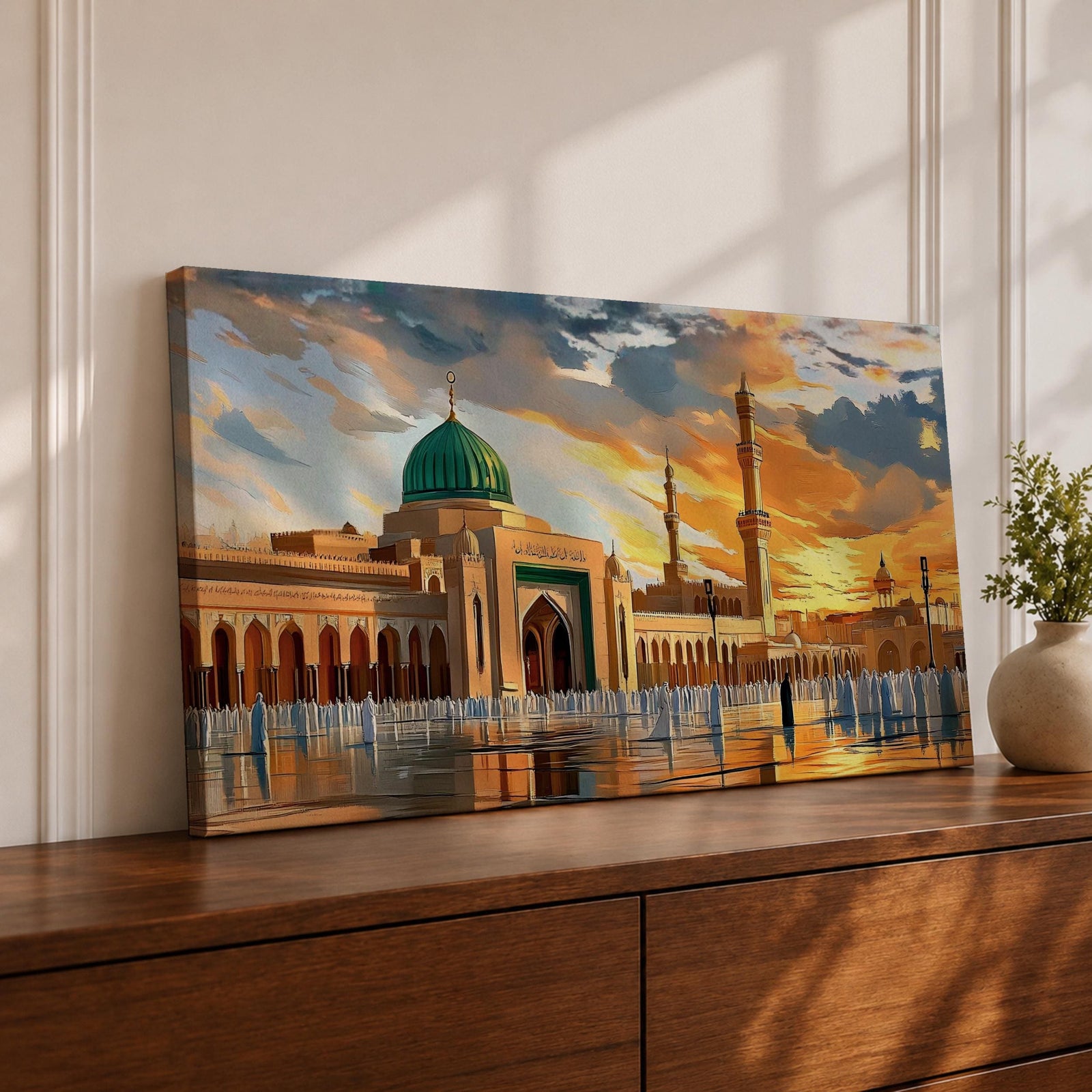 Panoramic painting of Al Masjid an Nabawi in Medina featuring the iconic green dome rising above the mosque courtyard with surrounding arcades and tall minarets. Pilgrims gather across the reflective marble plaza while dramatic sunset clouds illuminate the historic Islamic architecture.