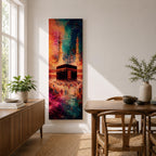 A tall narrow vertical depiction of the Kaaba in Mecca surrounded by a gathering of pilgrims, rendered in an abstract expressive style with bold layered brushwork, deep blues, warm oranges, and rich magenta tones blending into a textured composition that conveys movement, depth, and energy.