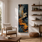A tall vertical artwork depicts a majestic phoenix with outstretched wings rendered in intricate feather detail, its white and gold plumage glowing against swirling dark blue and smoky cloud forms, while flowing golden flames trail from its body, blending Asian-inspired brushwork with dynamic movement and a mythic, firebird presence.