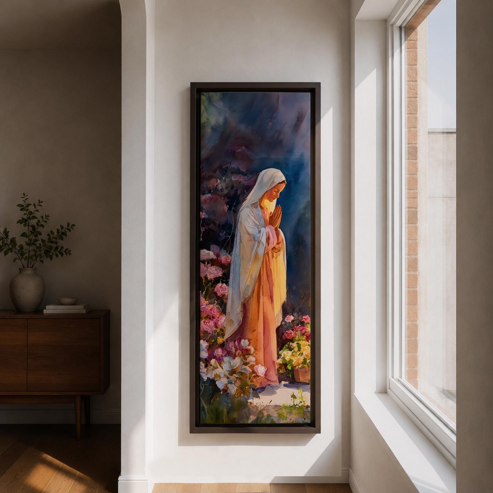 A tall narrow painting of the Virgin Mary standing in prayer with hands gently clasped, wearing a soft white veil over a flowing pink robe, surrounded by blooming flowers in rich pastel tones, set against a deep atmospheric background with expressive brushwork in a serene impressionistic style.